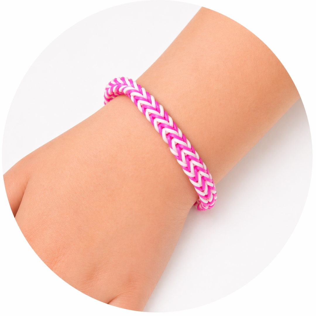 A hot-pink-and-white woven Blind Bag bracelet on a child's wrist.